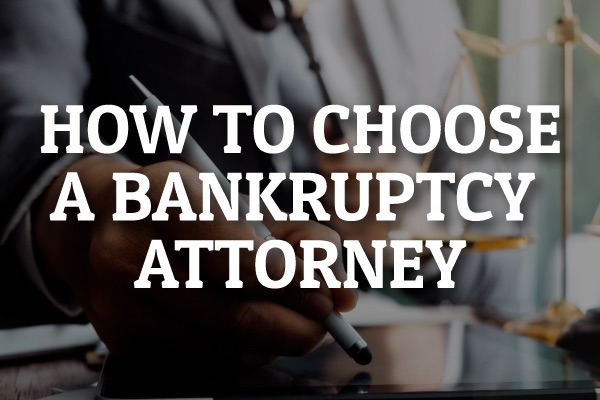 An attorney talking with a client with the words, "how to choose a bankruptcy attorney."